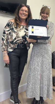 Gina Awad displaying her accredited celebrant certificate